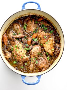Over the top image of coq au vin garnished with parlsey